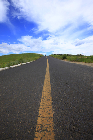 asphalt road on grasslandの写真素材