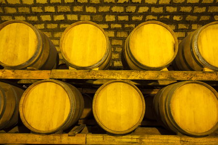 Wine barrels stacked in the cellar of the wineryの写真素材