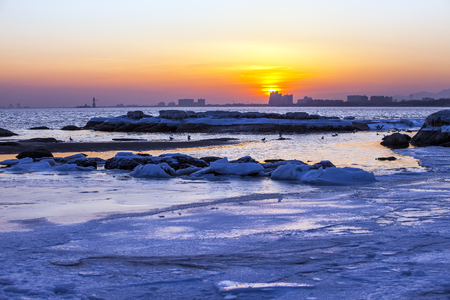 The sunset at the seaside in winterの写真素材