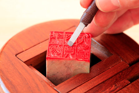 Chinese craftsman carving a stone sealのeditorial素材