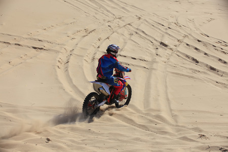 Cross-country motorcycle driving in the desertの写真素材
