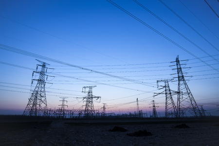 The silhouette of the evening electricity transmission pylonの写真素材