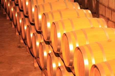Wine barrels stacked in the cellar of the wineryの写真素材