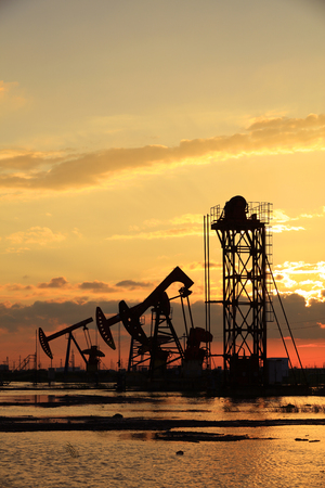 Oil fields in the evening, oil field derrick in the evening,  sunset and sunsetの写真素材