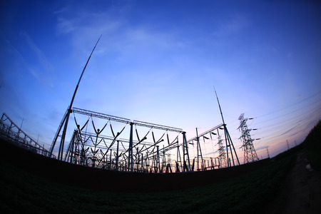 In the evening, high voltage towers silhouette and a beautiful sunsetの写真素材