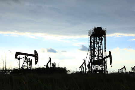 Oil field scene, oilfield derrick in the eveningの写真素材