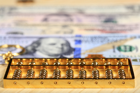 Gold abacus and the dollarの写真素材