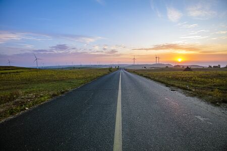 Roads and wind turbines in the eveningの写真素材