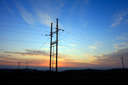 The electric pole is in the evening
