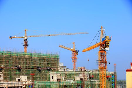 Tower cranes build residential buildingsの写真素材