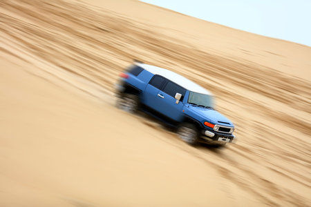 An suv was driving in the desert.