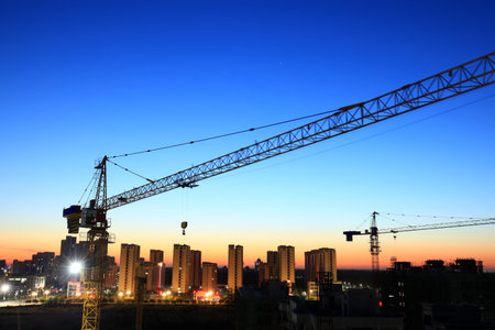 Tower cranes build residential buildings at nigh