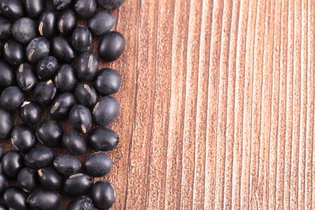 The black beans are on the wooden tableの写真素材