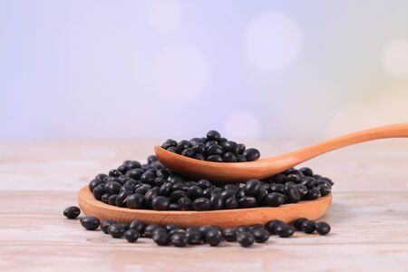 Black beans on  wooden tableの写真素材