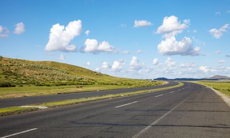 Empty highway, blue sky and white clouds landscapeの写真素材