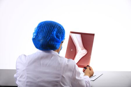 Woman Doctor Looking at X-Ray Radiography in patient's Room, doctor radiology looking x-ray film of patient at hospital.の写真素材