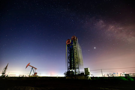 At night, oil pumps under the stars