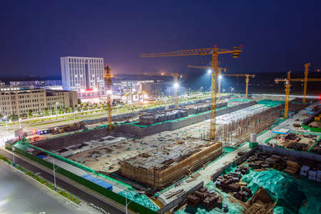 The building site is in the evening, Tower cranes build residential buildingsの写真素材