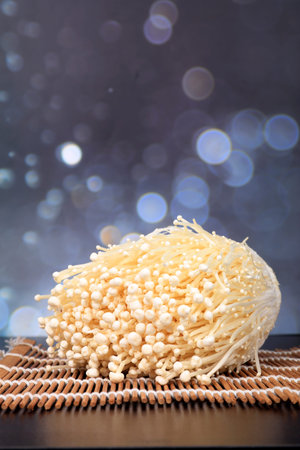 The fresh enoki mushroom are on the wooden tableの写真素材