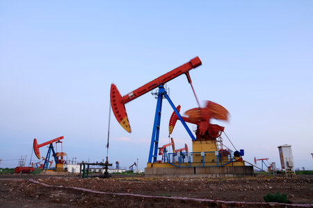 In the field, the oil pump in the evening, the evening silhouette of the pumping unit, the...