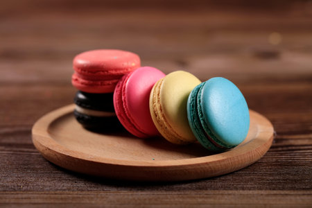 Macarons on a wooden plate, close-upの写真素材