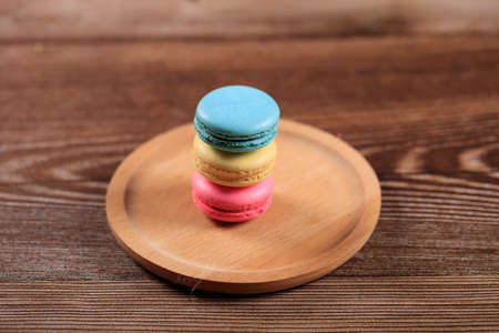 Macarons on a wooden plate, close-upの写真素材