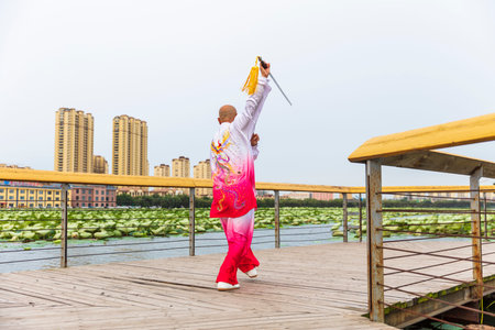 An old man performing Chinese martial arts, a man performing Chinese Taiji sword