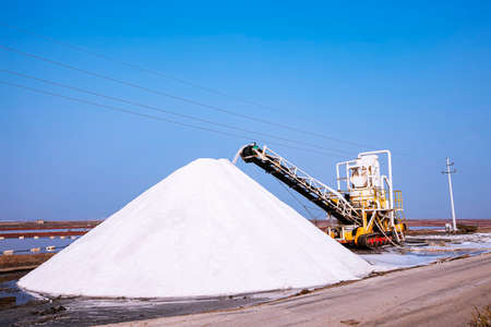 Sea salt production. machinery for the treatment of the salt, The salt making equipment in the salt farm is in operation, The equipment and salt stock of a salt plantの写真素材