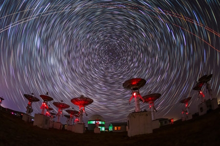 In observatories, satellite antenna radio telescope on the background of stellar tracks, radio...