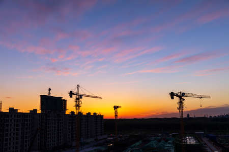The construction site is in the evening, Silhouette of the tower crane in the eveningの写真素材