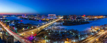 The city by the river is at night, Roads and traffic flow at nightの写真素材