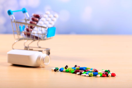 Buy and shopping medicine concept. Various capsules, tablets and medicine in shop trolley. Creative...