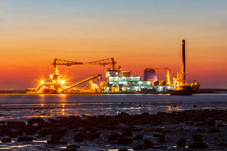 The dredger is at night, the dredger is at seaの写真素材