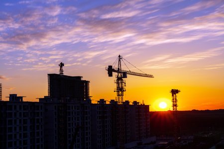 The construction site is in the evening, Silhouette of the tower crane in the eveningの写真素材