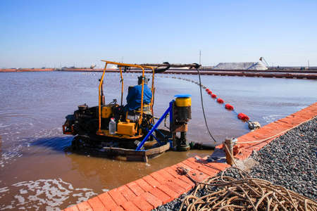 Workers work on the salt field, Salt-farm workers produce salt in the salt fields, salt-farm equipment produces saltの写真素材
