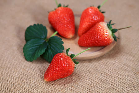Fresh strawberries on the plate, fresh strawberries on the table, close-upの写真素材