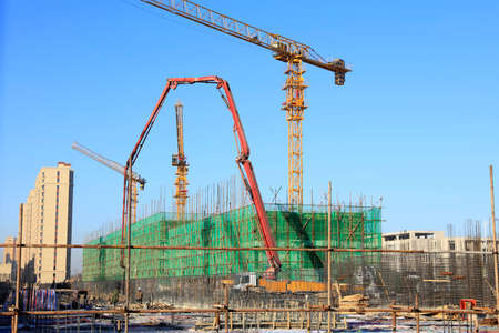 The construction site, the construction worker's tower crane, Residential buildings are under constructionの写真素材