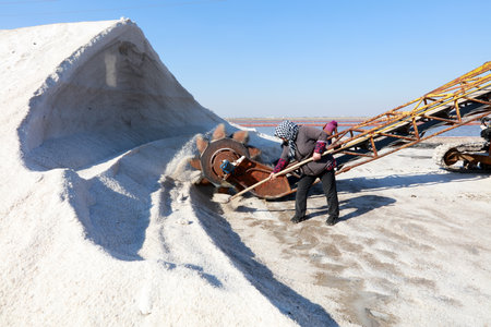 Workers work on the salt field, Salt-farm workers produce salt in the salt fields, salt-farm equipment produces saltの写真素材