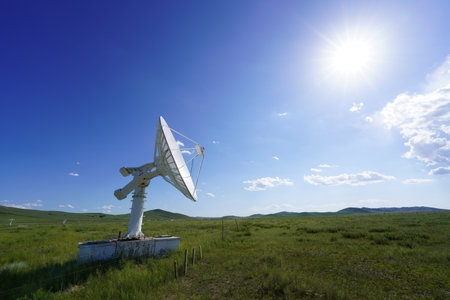The observatory's radio telescope, The radio telescope is on the grasslandの写真素材