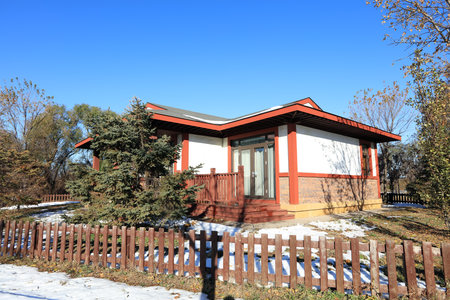 In winter, the wooden houses are under the blue sky, the beautiful wooden villas are under the blue skyの写真素材