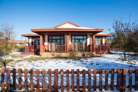 In winter, the wooden houses are under the blue sky, the beautiful wooden villas are under the blue skyの写真素材