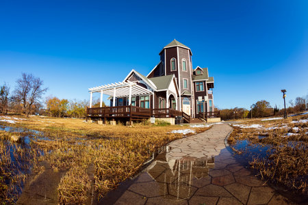In winter, the wooden houses are under the blue sky, the beautiful wooden villas are under the blue skyのeditorial素材