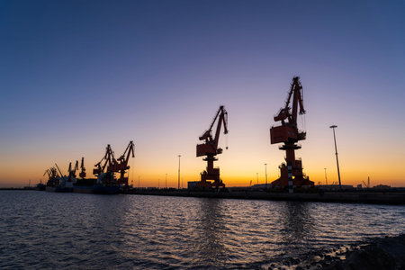 Gantry crane and cargo ship in the evening, Shipping and logistics concept