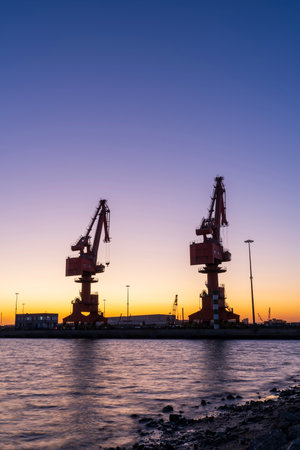 Gantry crane and cargo ship in the evening, Shipping and logistics conceptの写真素材