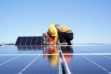 Workers install solar photovoltaic panels, Workers repair solar photovoltaic power generation equipmentの写真素材