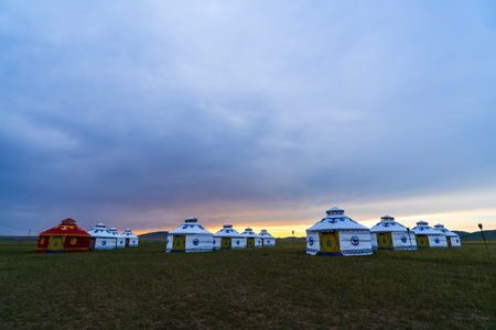 The yurt is under the blue sky and white clouds, yurts in the beautiful grassland, Mongolian yurt on the grassland.の写真素材