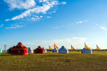 The yurt is under the blue sky and white clouds, yurts in the beautiful grassland, Mongolian yurt on the grassland.の写真素材