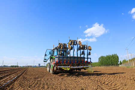 In spring, farmers use farm machinery to grow peanuts.の写真素材