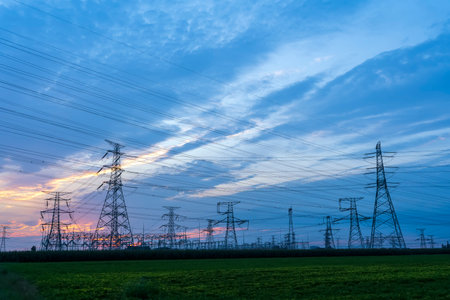 The pylons are in the evening, Substation in the evening, the silhouette of the power supply facilities, High voltage substation and beautiful sunset glowの写真素材
