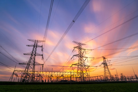 The pylons are in the evening, Substation in the evening, the silhouette of the power supply facilities, High voltage substation and beautiful sunset glowの写真素材